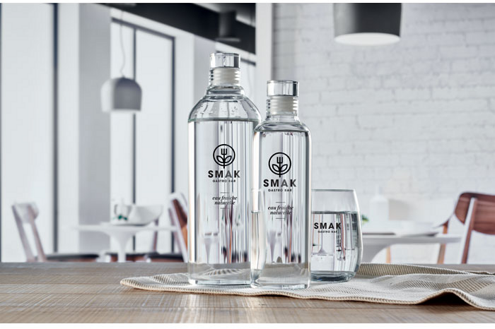Zwei Glaskaraffen und ein Wasserglas stehen auf einem Tisch. Alle Gegenstände sind mit einem schwarzen Rundum Siebdruck bedruckt.